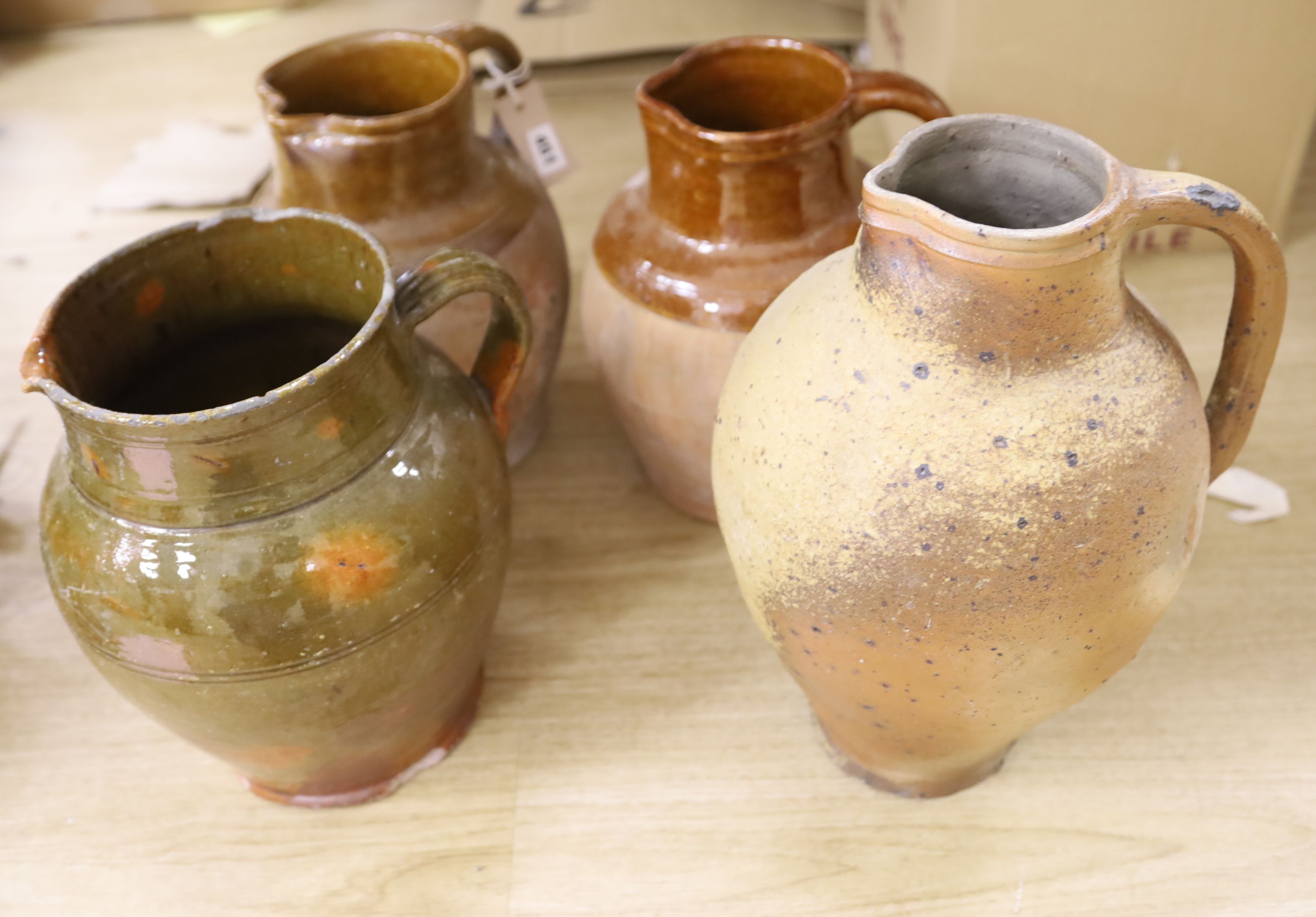 Four Sussex pottery jugs, tallest 34cm